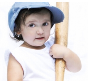 child supporting her bat